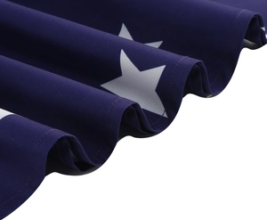 Detail of navy blue sleeveless dress with white stars and premium stitched edges