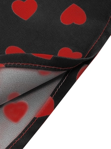 Detail of red heart prints on black fabric with reinforced stitching on the edge
