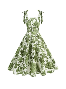 Detail of vintage white dress with green floral print, square neck and shoulder ties