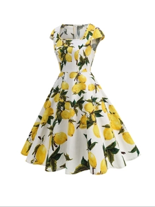 Detailed close-up of retro floral dress featuring vibrant lemon prints and green leaves