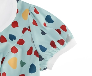 Close-up of light blue floral dress with puffed sleeves and colorful heart print