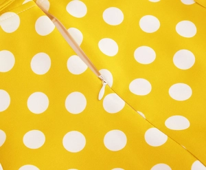 Detail view of high-quality invisible zipper on yellow polka dot cotton dress