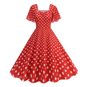 Detail of red vintage square neck dress with white heart patterns and flutter sleeves
