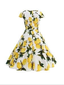 Close-up of vintage A-line dress featuring realistic yellow lemon and green leaf prints