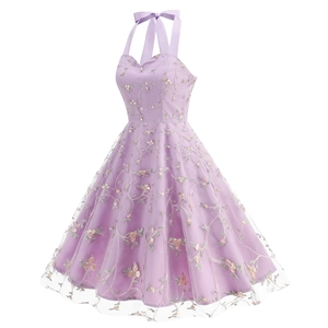 Close-up of elegant floral embroidery and delicate mesh overlay on purple halter dress