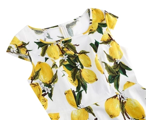 Detail of summer sleeveless white dress with vibrant yellow lemon and green leaf prints