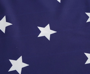 Detailed macro view of navy blue fabric with white five-point stars and clear texture