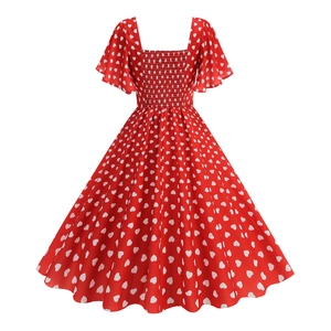 Detail of vintage red dress with square neck, smocked bodice and white heart patterns