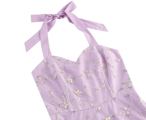 Detail of lavender mesh dress featuring intricate floral embroidery and silk neck ribbon