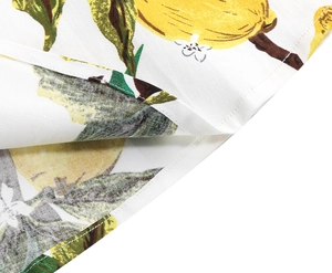 Detailed close-up of lemon floral print fabric with high-quality flat seam stitching details