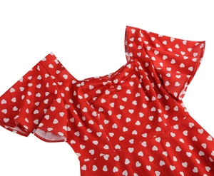 Detail of square neckline and flutter sleeves on red heart print dress