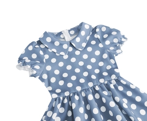 Detail of baby girl cotton dress with polka dot pattern and a classic Peter Pan collar