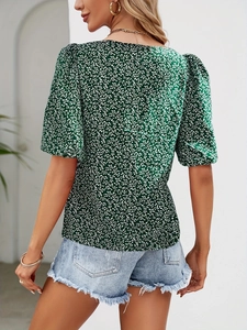 Detail view of floral v-neck top with puff sleeves and leaf pattern for summer