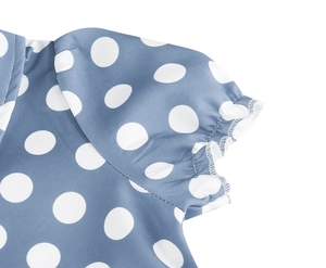 Detailed macro view of polka dot puff sleeves with elastic cuffs and ruffle edges