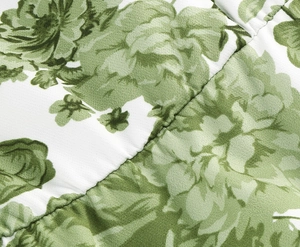 Detailed close-up showing the vintage green floral print and stitching on women's dress