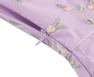 Detail of purple mesh dress showing delicate floral embroidery and invisible zipper