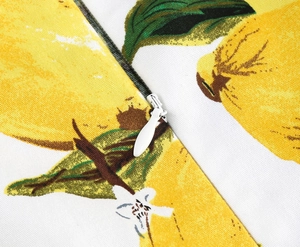 Close-up of lemon print fabric with high-quality white hidden zipper and sewing details