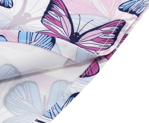 Macro detail of high-quality butterfly print and neat edge stitching on floral girls' dress