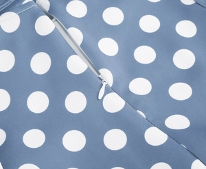 Close-up detail of white invisible zipper on light blue polka dot cotton dress