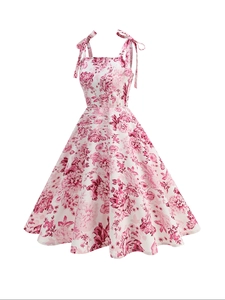 Detail of elegant vintage floral print dress featuring shoulder bow ties and A-line silhouette