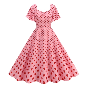 Close-up of pink A-line dress with red heart print and heart-shaped neckline detail