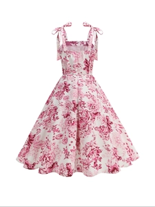 Detail of floral spaghetti strap dress with pink flowers and bow tie shoulders