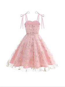 Détail de dentelle rose brodée sur robe en tulle avec motifs floraux de feuilles vertes