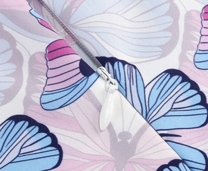 Detail of high-quality invisible white zipper on girl's floral printed cotton dress