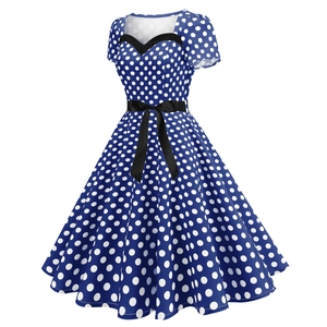 Detail of vintage royal blue polka dot dress with sweetheart neckline and black bow belt