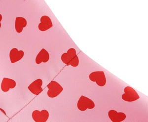 Detail of red heart patterns on pink fabric with fine stitching for women's dress
