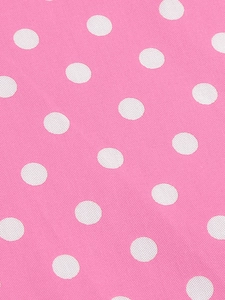 Gros plan du tissu à pois roses pour la matière de robe d'été vintage pour filles
