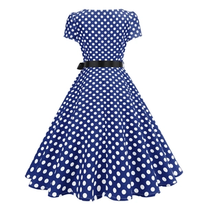 Detail of vintage polka dot dress featuring a black waist belt and flared A-line skirt