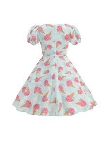 Detail of baby blue vintage girl dress featuring puff sleeves and floral ice cream print