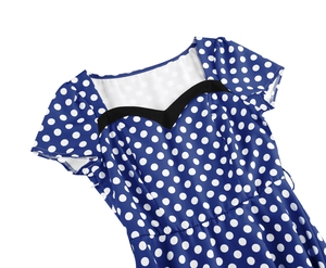 Close-up of vintage navy polka dot dress showing heart-shaped neckline and short sleeves