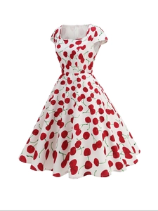 Close-up of retro white A-line dress with red cherry print and elegant square neckline