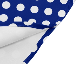 Detailed view of royal blue polka dot fabric with high-quality finished edge stitching