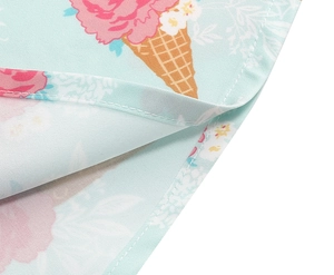 Close-up of floral ice cream print on light blue fabric with neat hem stitching details