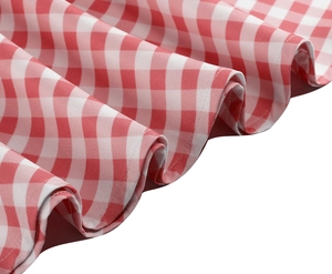 Detailed view of red gingham dress with pleated hem and fine stitching details