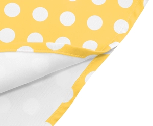 Detail showing high-quality white polka dot print on yellow fabric with smooth inner lining