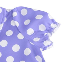 Close-up of lavender polka dot cotton fabric with elastic cuff and stitched shoulder seam