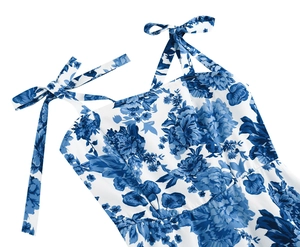 Detail of blue floral print on white fabric with adjustable tie-up bow shoulder straps