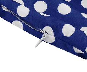Detail shot of invisible white zipper on navy blue polka dot vintage dress fabric