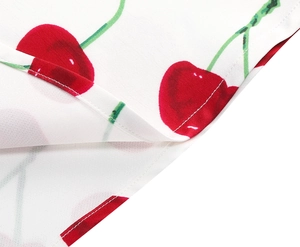 Detailed close-up of vibrant cherry print fabric with double-needle stitching quality