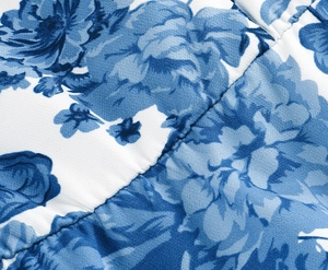 Macro shot of blue floral print fabric with twill texture and neat stitching detail