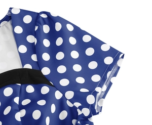 Close-up of royal blue polka dot dress showing puffy sleeve and stitching details