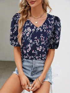 Elegant navy blue V-neck floral blouse with stylish puff sleeves for a casual summer look