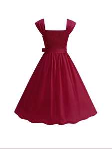 Detail view of the smocked bodice and square neckline on a burgundy sleeveless dress