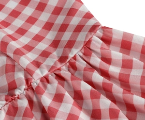 Detail shot of elegant red and white gingham fabric with exquisite ruffling craftsmanship