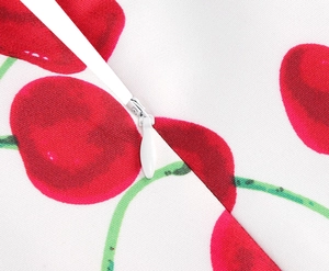Detailed view of invisible white zipper on vintage cherry print floral summer dress