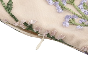 Detailed view of invisible zipper and floral embroidery on a vintage mesh dress